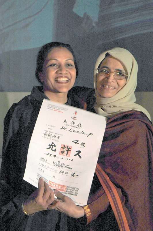 Dr. Leela receiving her Spochan rank certificate
